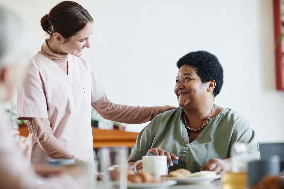 nurse talking to an adult with disabilities at day care center