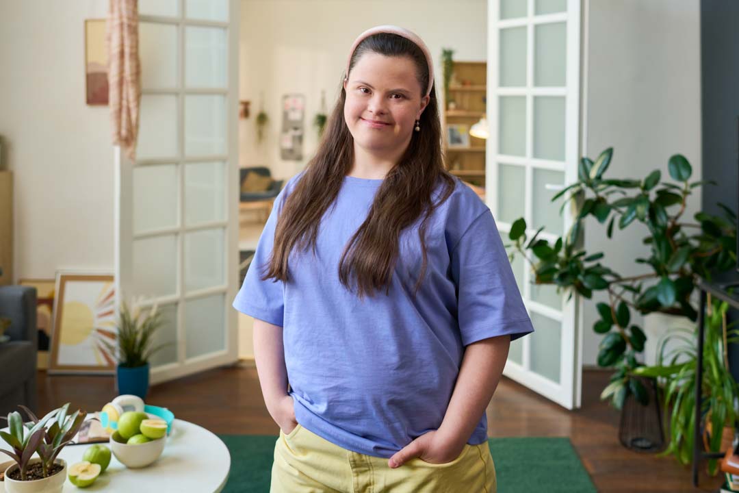 young woman with down syndrome smiling in adult day center