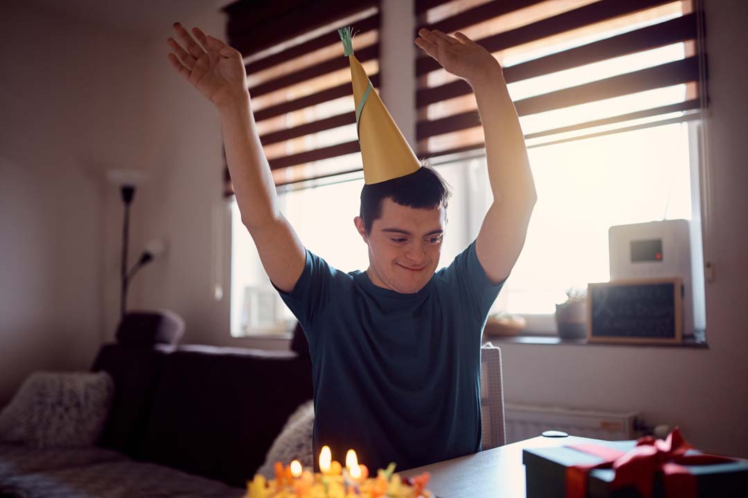 happy man with down syndrome celebrating his birthday