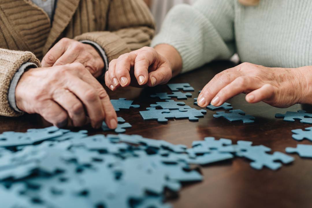retired couple putting together a puzzle