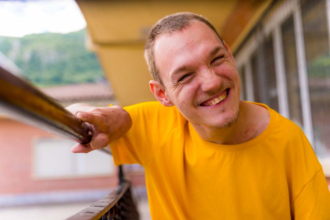 smiling man in a yellow shirt