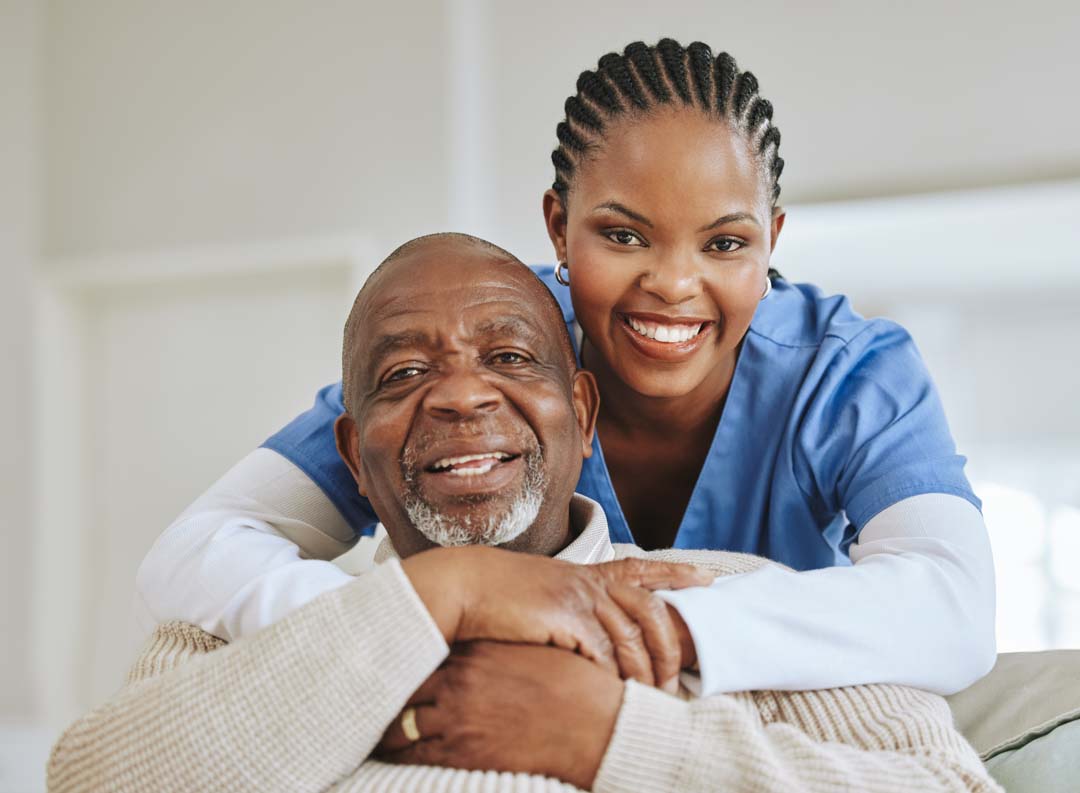 adult day care female nurse smiling with a male senior citizen