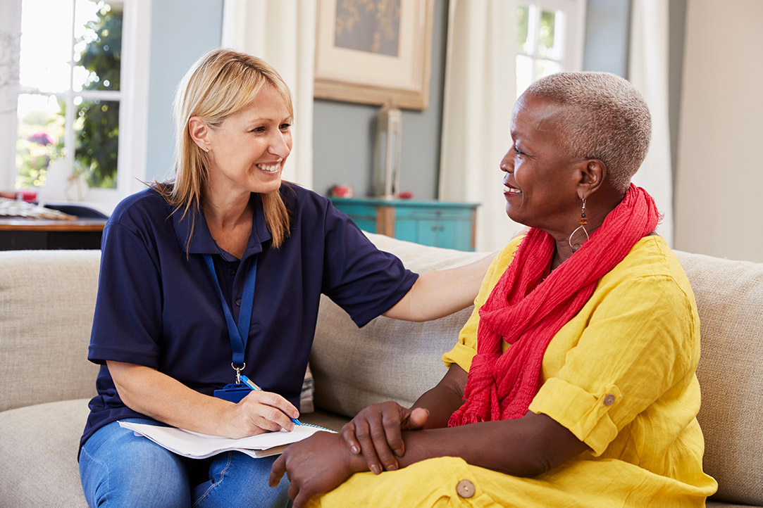 female support worker visits senior woman at home