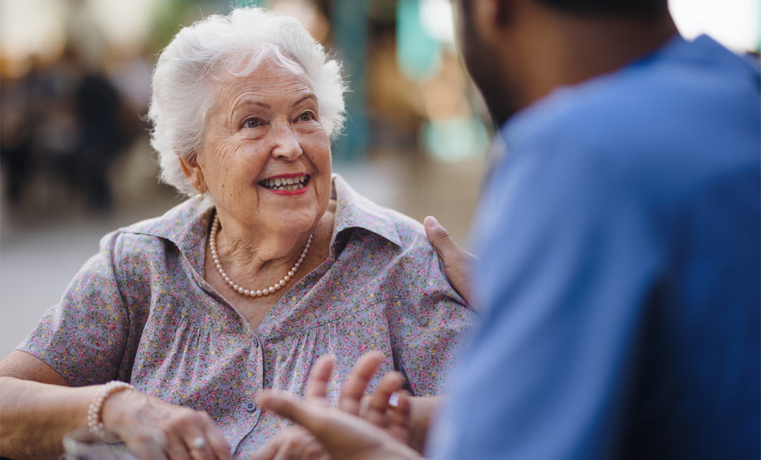 caregiver talking with his client at a cafe